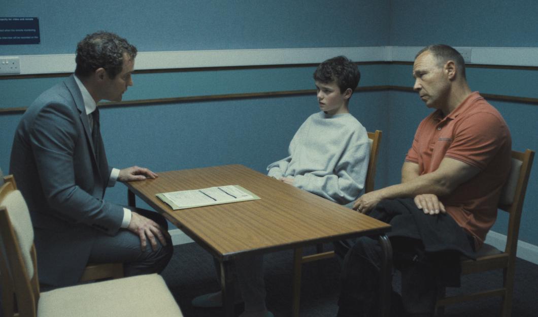 Scene from Adolescence showing three people sitting around a table.