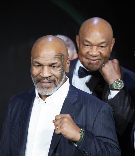 Mike Tyson and George Foreman at a gala.