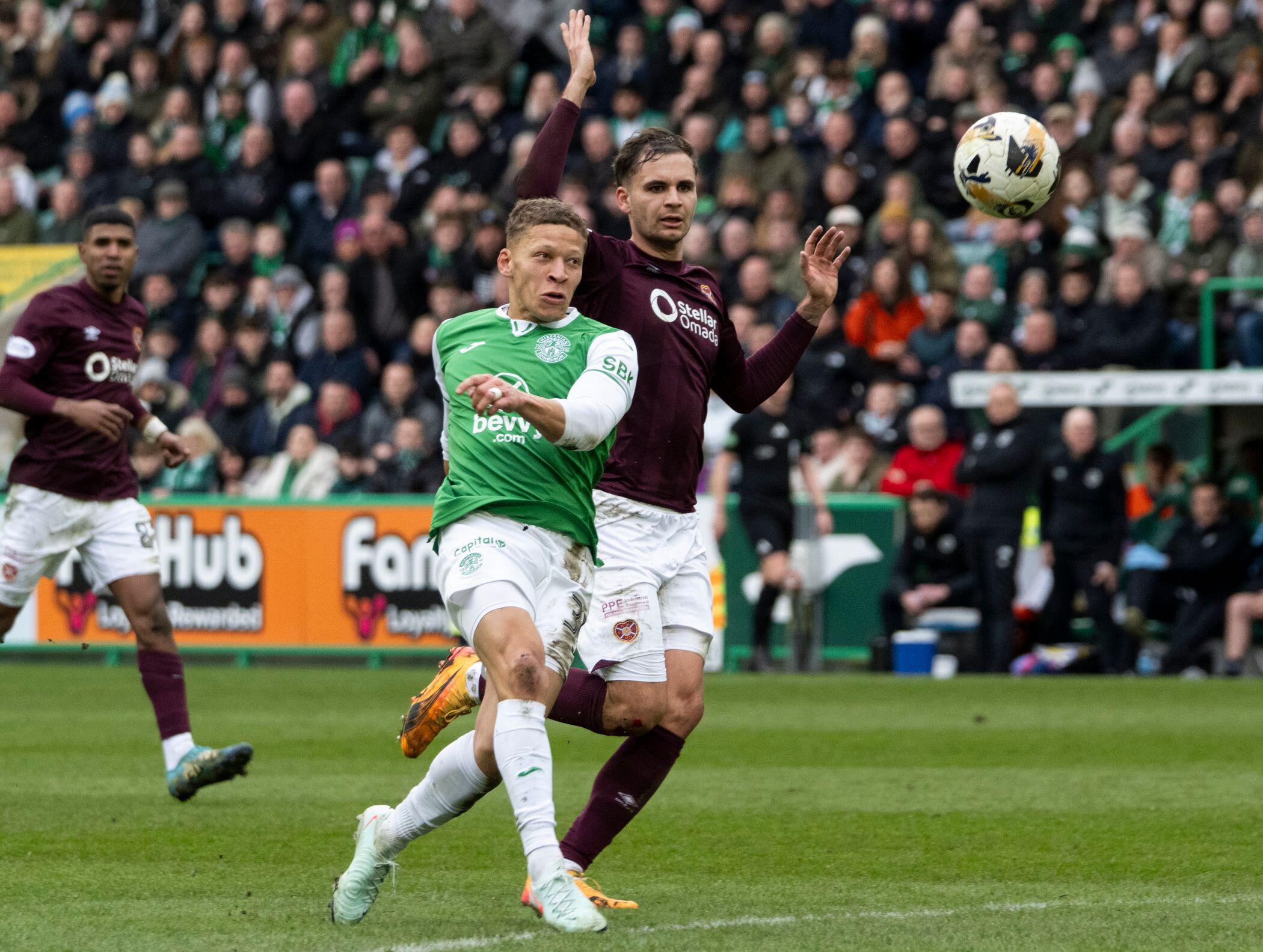 Dwight Gayle of Hibernian FC attempts a shot on goal during a match against Heart of Midlothian FC.