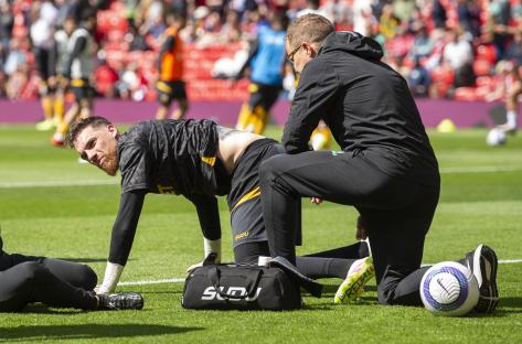 Soccer player receiving treatment on the field.