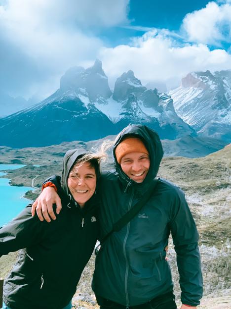 Couple smiling in front of mountains.