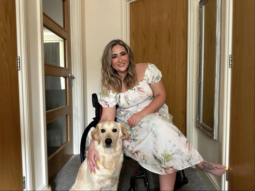 Woman in wheelchair with her assistant dog.