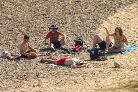 People relaxing on a pebble beach.
