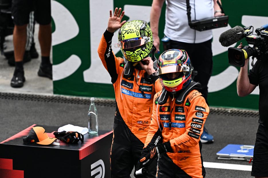 Lando Norris and Oscar Piastri on the podium after a Formula 1 race.