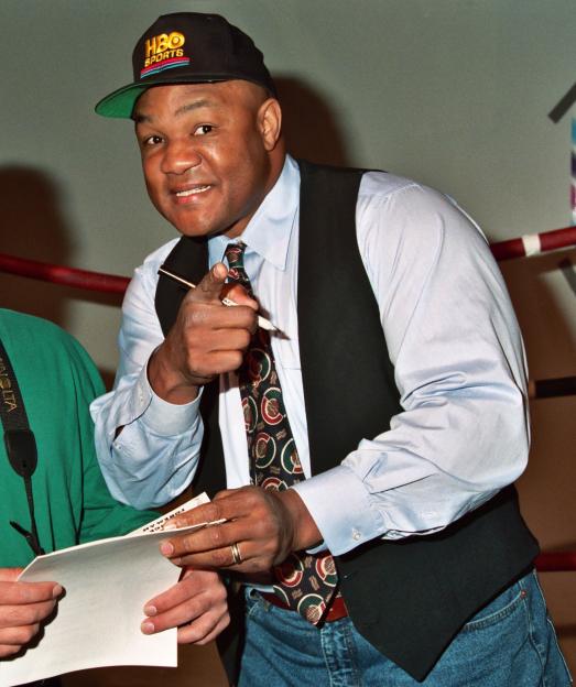 George Foreman signing an autograph.