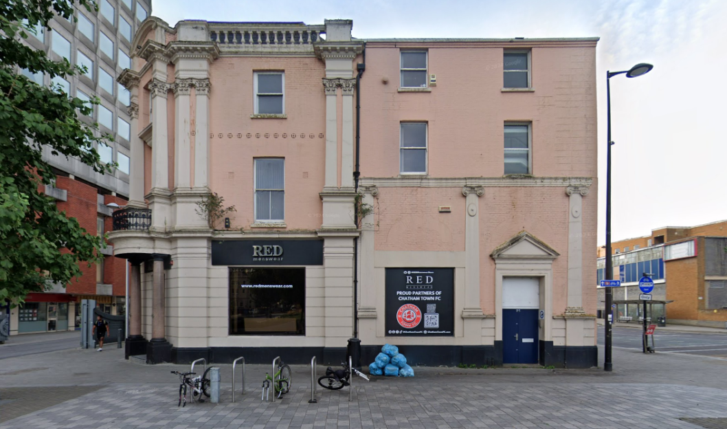 Photo of a pink building with a "RED menswear" sign.