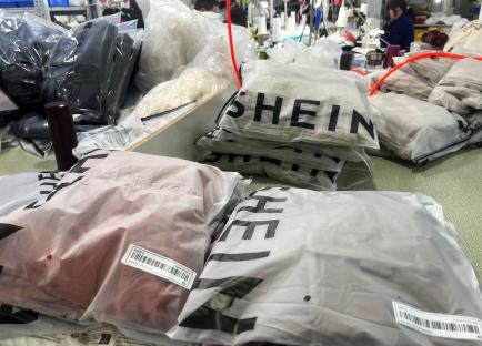Shein clothing in plastic packaging at a garment factory.