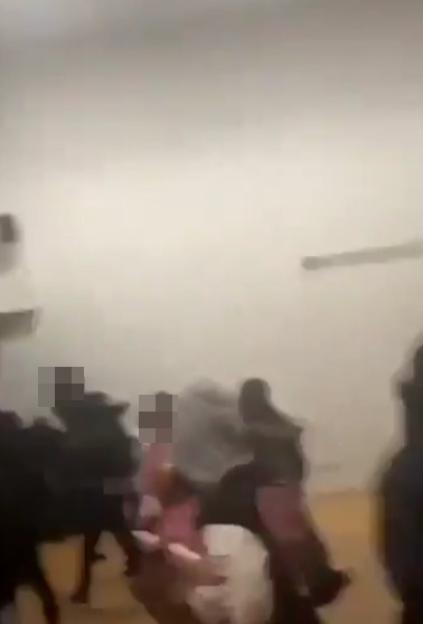 A blurry image of a school altercation.