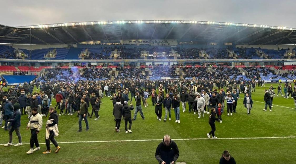 Reading fans on the pitch protesting club ownership.