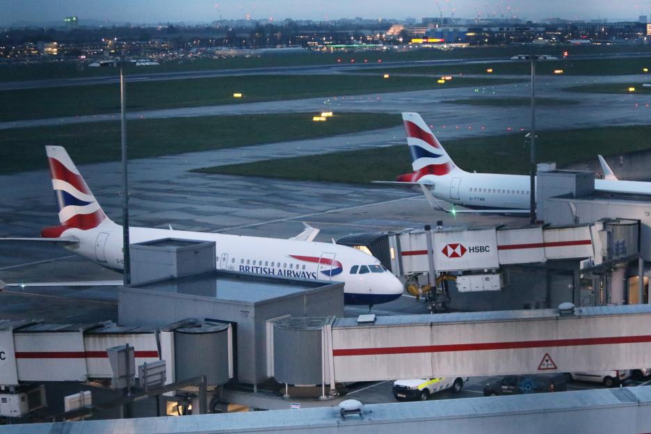 British Airways planes at an airport gate.