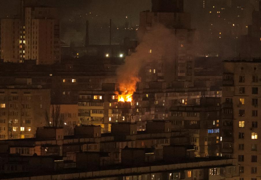 Apartment building on fire at night in Kyiv, Ukraine.