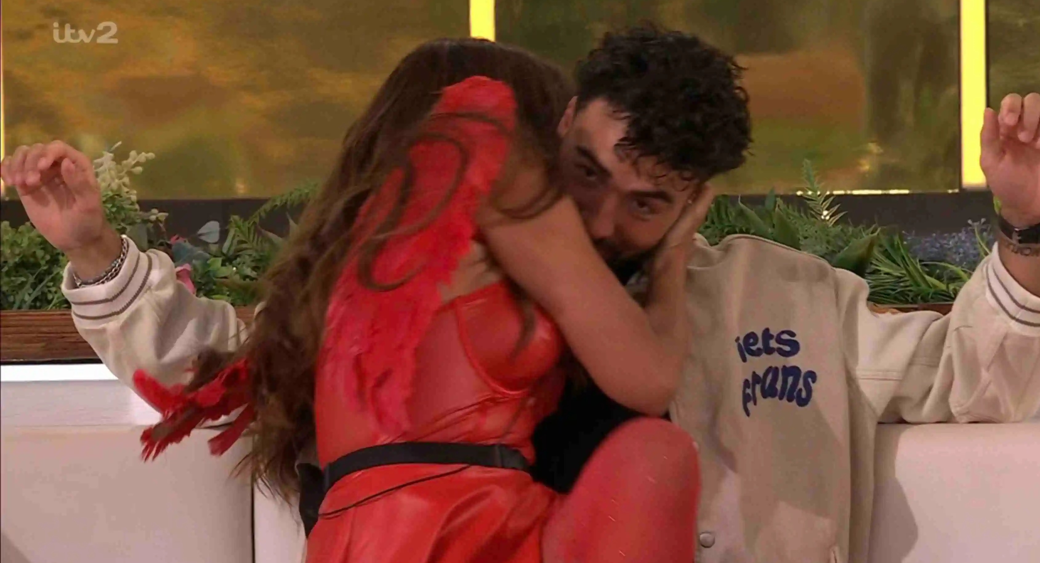 Screenshot from Love Island showing Ekin-Su and a man embracing.