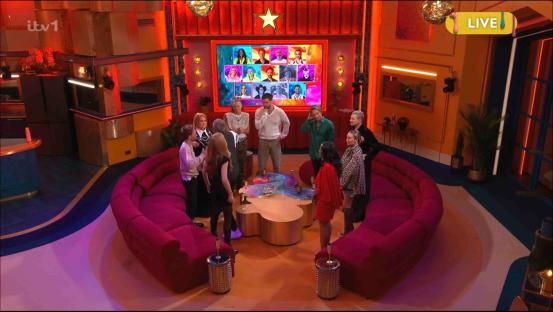 A group of people sitting on a curved sofa in a brightly lit studio.