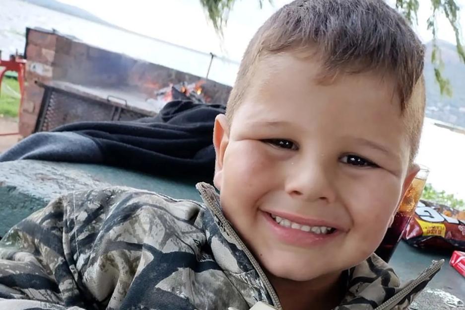 Boy, 7, fighting for life after crocodile rips arm off while he was playing just a few feet from parents on fishing trip