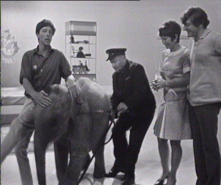 Black and white photo of John Noakes, Valerie Singleton, and Peter Purves with Lulu the elephant on Blue Peter.