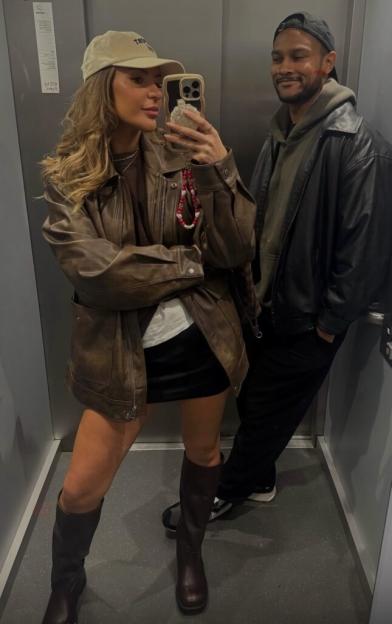 Couple taking a selfie in an elevator.