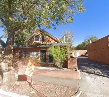 Photo of a building in Santa Fe, New Mexico with a "Road Work Ahead" sign.