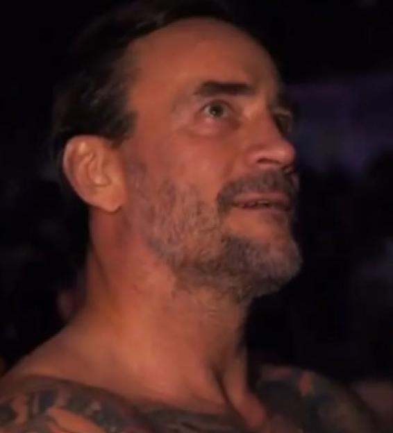 CM Punk with bloodshot eyes, appearing emotional.