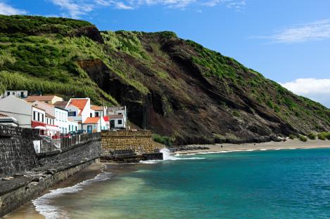 Houses on Faial Island, Azores, overlooking a beach and ocean.