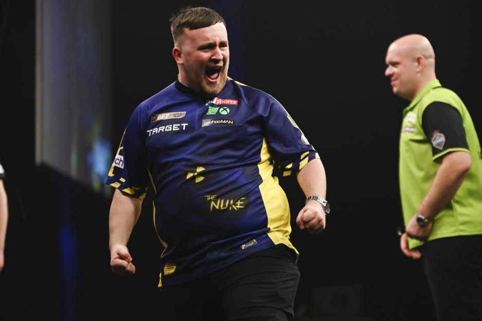 Luke Littler celebrates a nine-darter during a darts match.