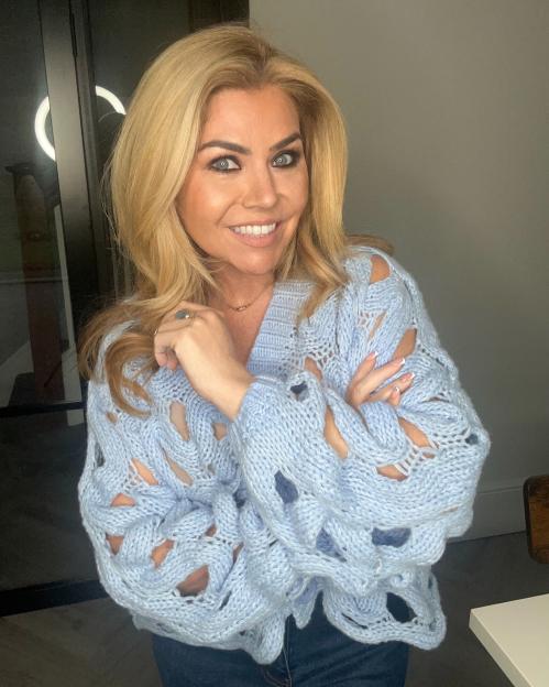 Woman in light blue knit sweater.