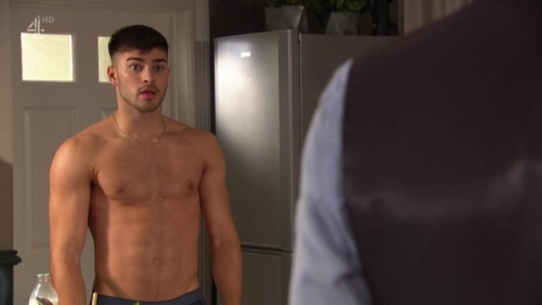 Owen Warner from Hollyoaks shirtless in a kitchen.