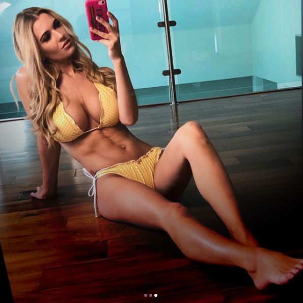 Woman in yellow bikini taking a selfie.