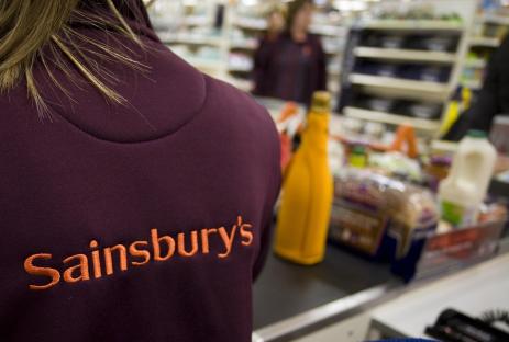 Sainsbury's employee's back at checkout.