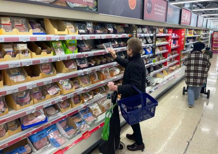 A customer shopping for cooked meat in a Sainsbury's supermarket.