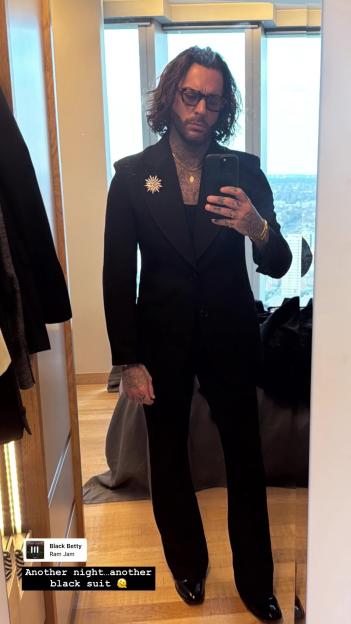 Pete Wicks in a black suit.