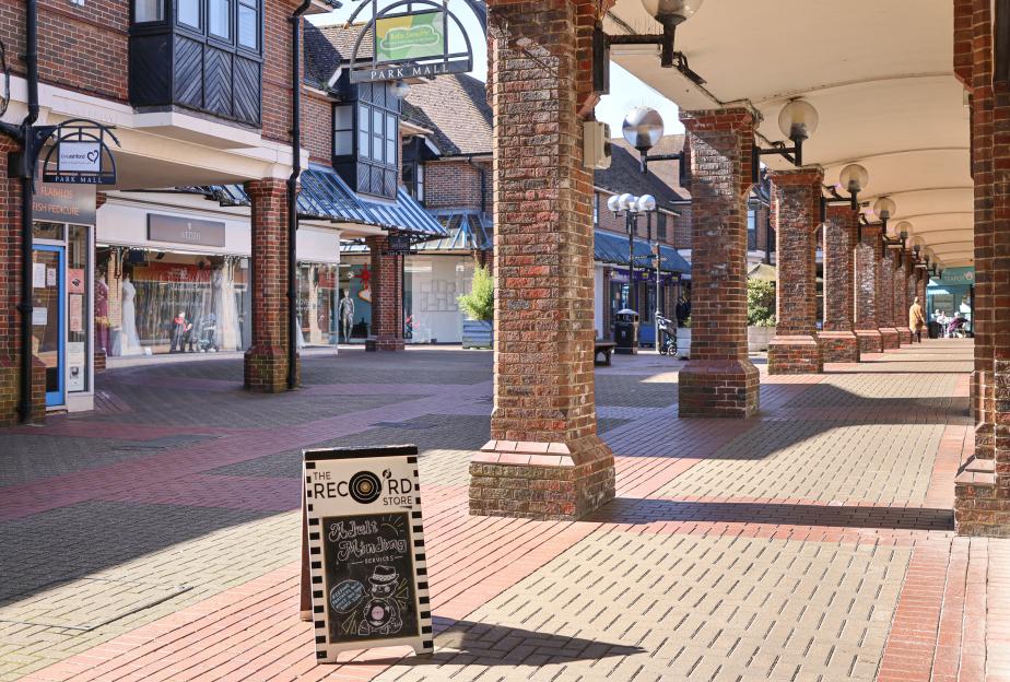 Empty Ashford, Kent shopping mall with a record store sign.