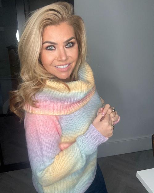 Radio presenter wearing a pastel rainbow sweater.