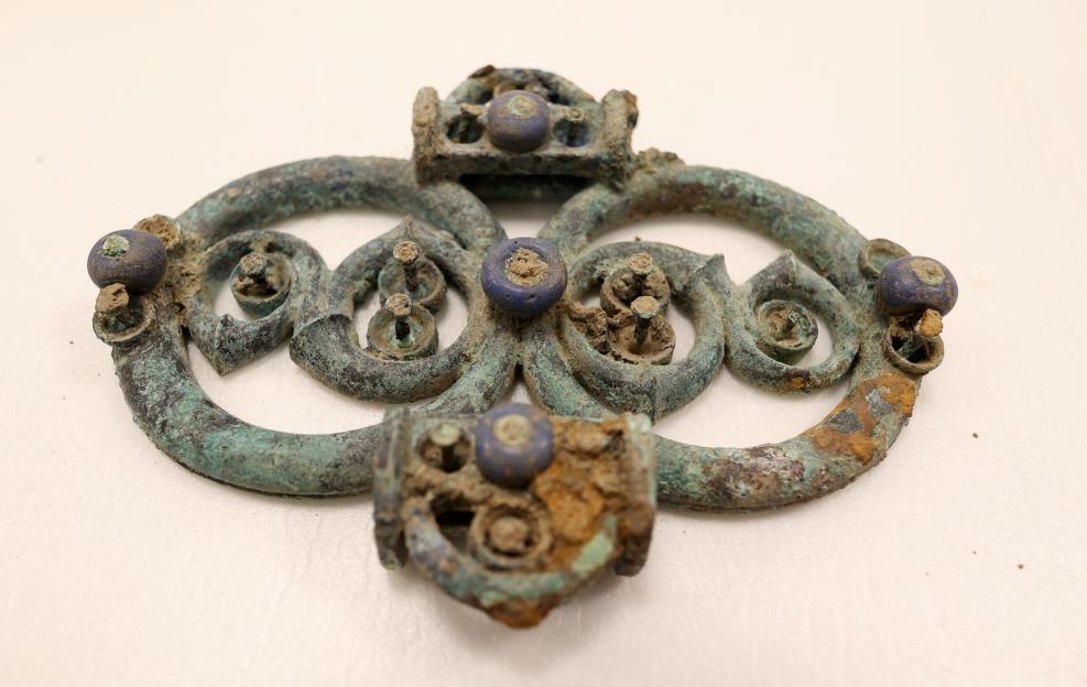 Copper alloy strap union with blue glass decoration from the Melsonby Hoard.