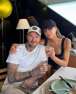 Victoria and David Beckham celebrating on a yacht.