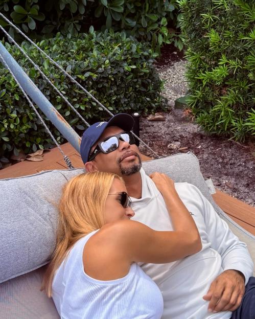 Tiger Woods and Vanessa Trump cuddling in a hammock.