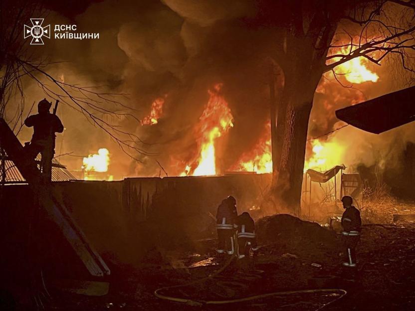 Ukrainian rescuers battling a large fire following a drone attack in Kyiv.