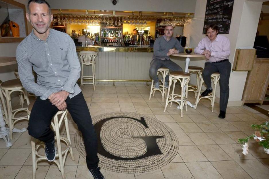 Three men sitting in a restaurant.