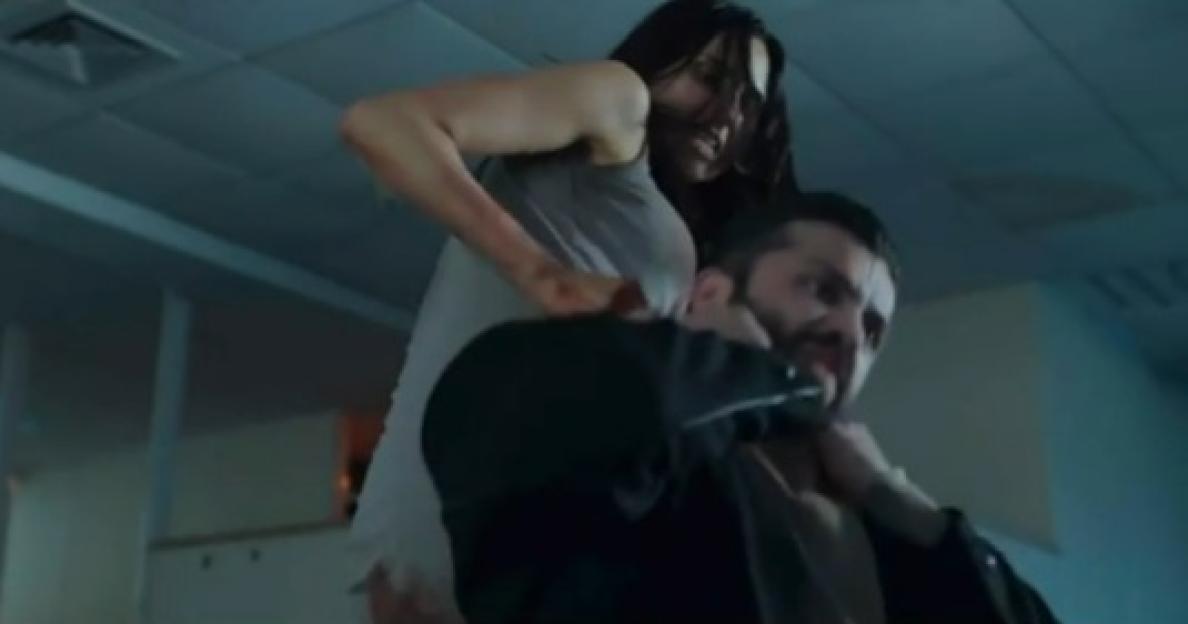 Screenshot of a woman choking a man.