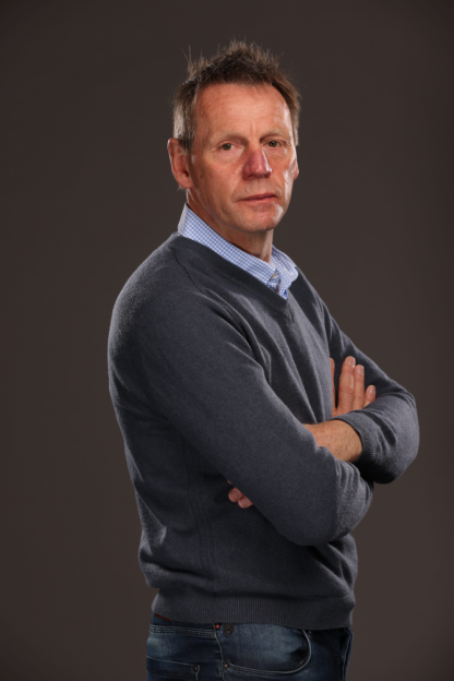 Portrait of a man with arms crossed.