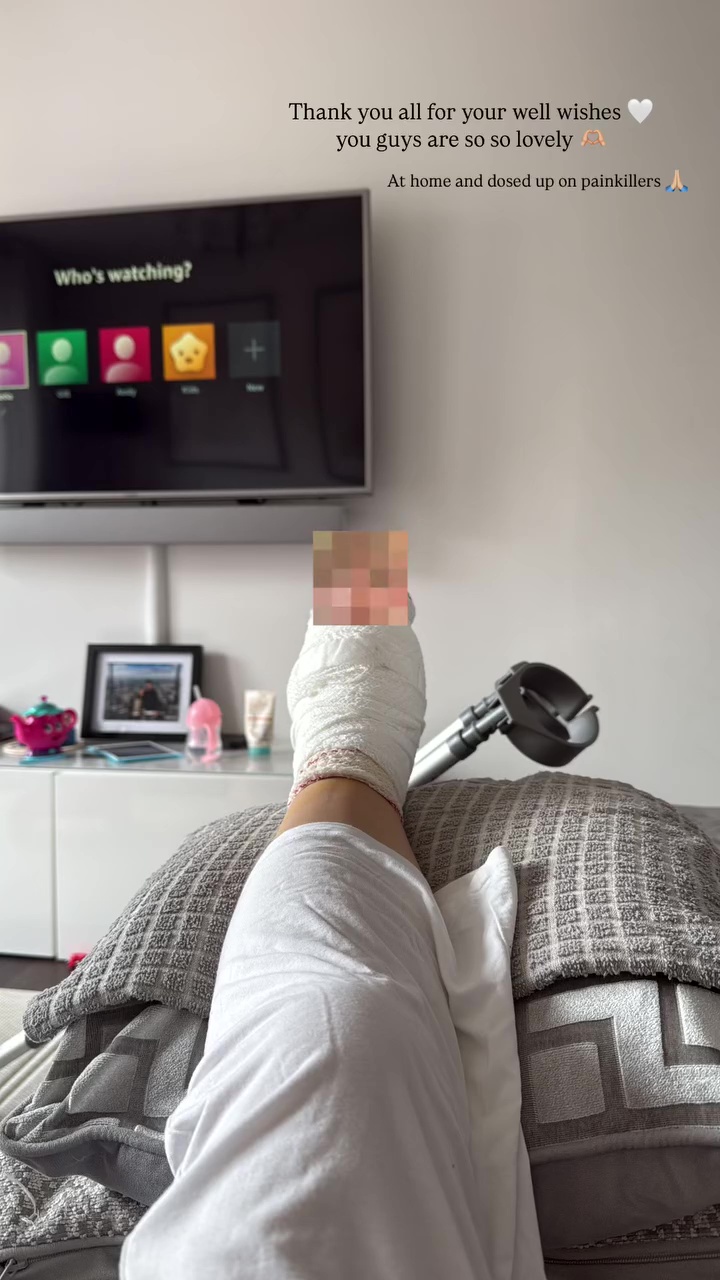 Bandaged foot resting on pillows; person is at home recovering.