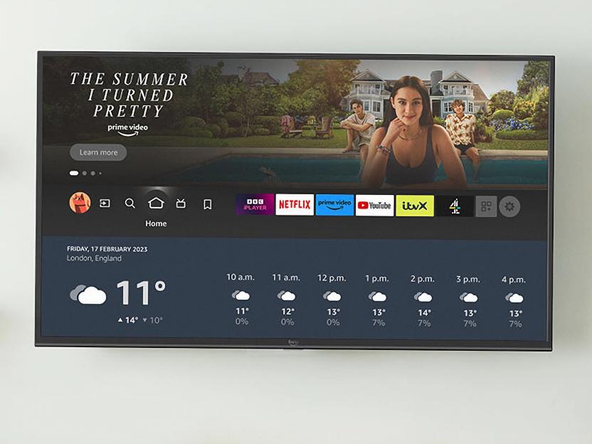 Amazon Fire TV displaying "The Summer I Turned Pretty" on Prime Video, along with various app icons and weather forecast.