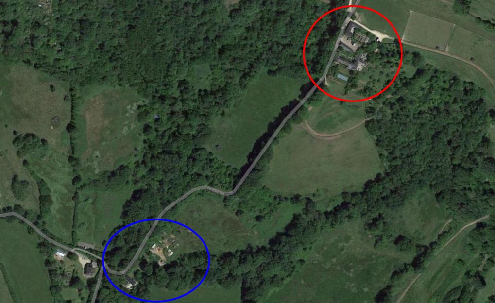 Aerial view of two properties, one a farmhouse, the other a potential travellers' site.