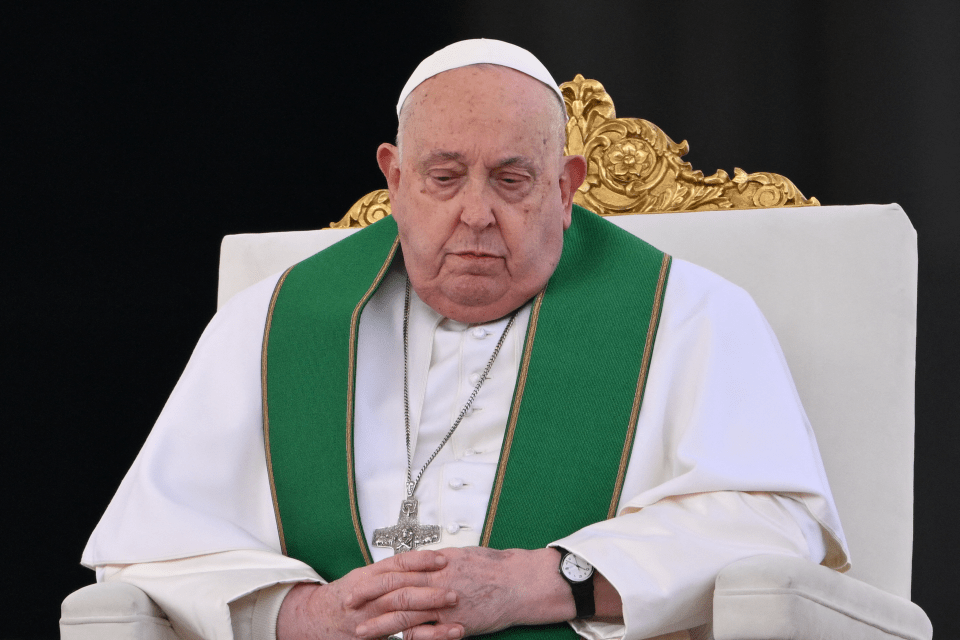 Pope Francis seated in a chair.