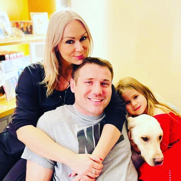 Kristina Rihanoff, Ben Cohen, and their daughter with their dog.