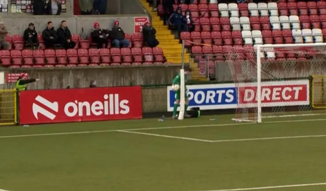 Soccer goalie tending goal.