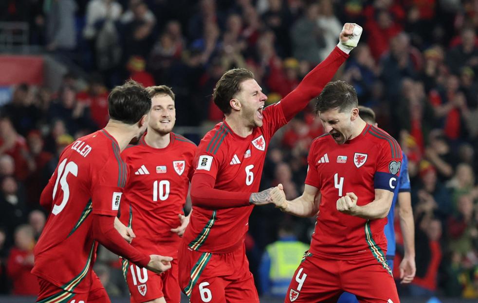 Wales soccer players celebrating a goal.