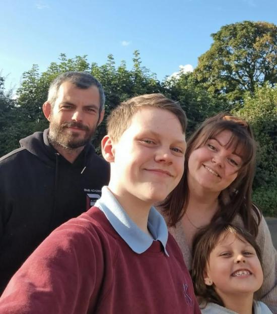 Family selfie outdoors.