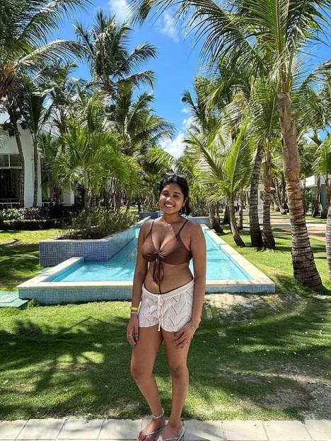 Photo of Sudiksha Konanki in swimwear by a resort pool.