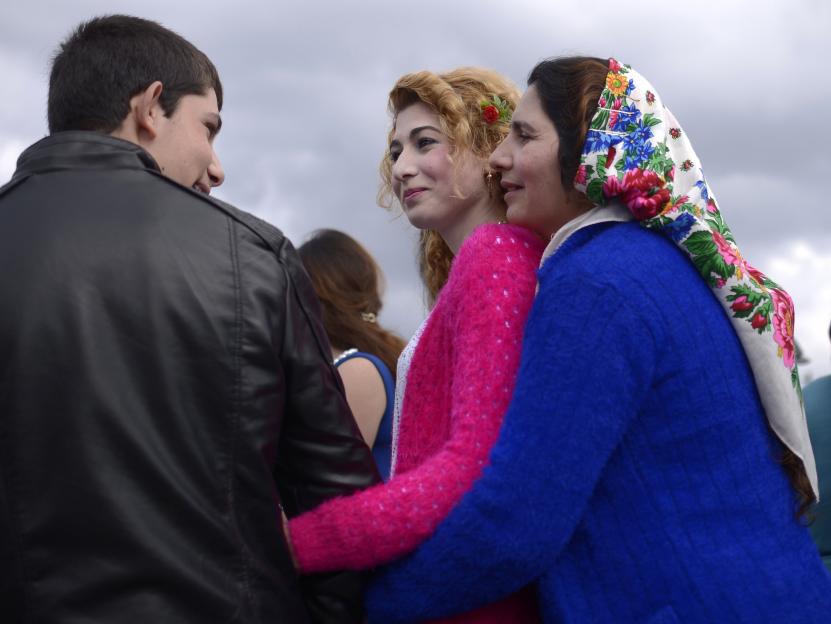 Roma woman embracing her daughter at a bride market.