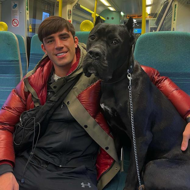 Jack Fincham and his Cane Corso dog, Elvis, on a train.